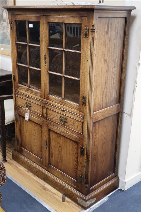 An 18th century style oak dresser with glazed upper section. Plinth has a concealed drawer. W.104cm., D.45cm., H.152cm.